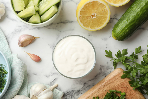 Flat lay composition with cucumber sauce and ingredients on marble background - Foto, Imagen