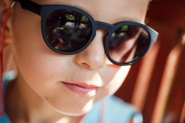 Portrait of a beautiful baby boy in sunglasses - 写真・画像