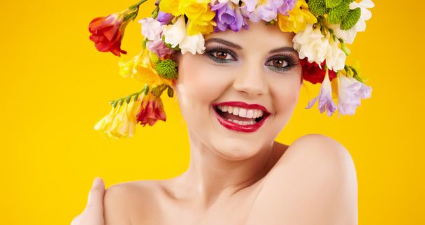 Woman with hairstyle and flower. Isolated on yellow - Foto, Imagen
