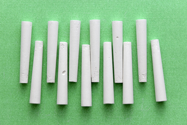 Some white chalk on green background - Photo, Image