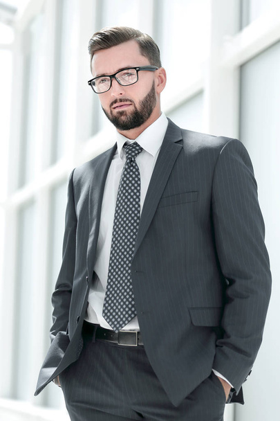 serious businessman standing in a spacious office - Fotografie, Obrázek