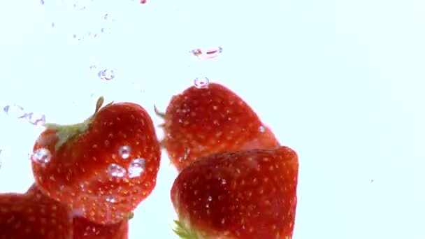 Beautiful slow motion of red strawberries falling into water - Footage, Video