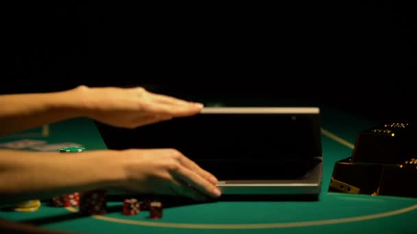 Hands opening laptop, poker chips and wealth around, temptation to hit jackpot - Кадры, видео