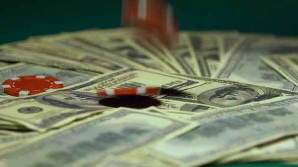 Casino chips falling on dollar bills, big winnings, jack-pot, slow-motion - Кадри, відео