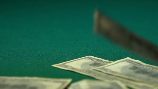 Many hundred-dollar bills falling to green table, winning big jackpot, close-up - Séquence, vidéo