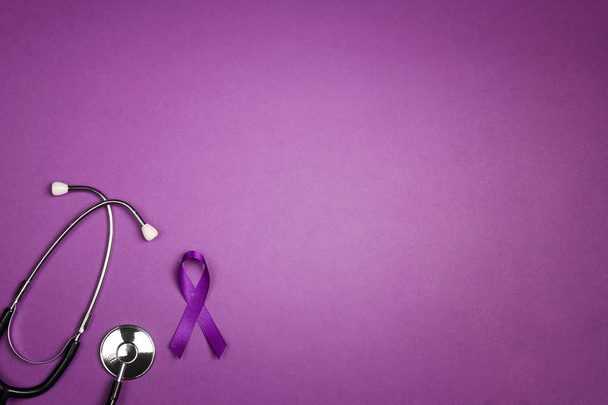 Purple epilepsy awareness ribbon with stethoscope and copy space - Photo, Image