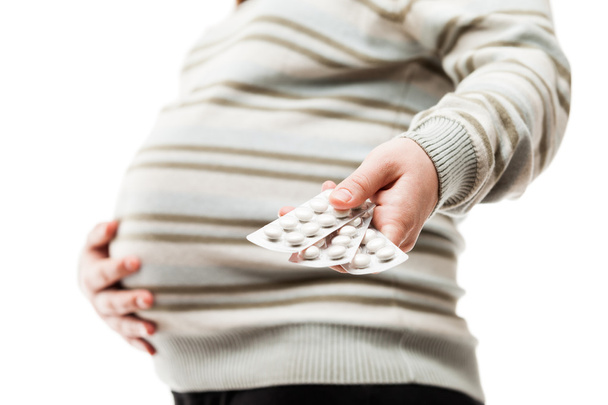 Pregnant woman holding vitamin pills - Foto, imagen