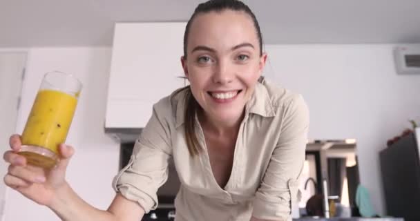 Smiling woman with healthy beverage in kitchen - Video