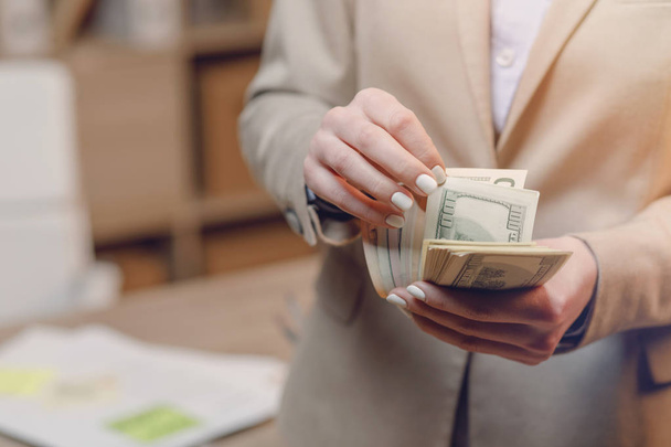 Businesswoman with cash. Hand holding dollar money. - Фото, изображение