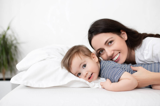 mother and baby boy on bed - Valokuva, kuva