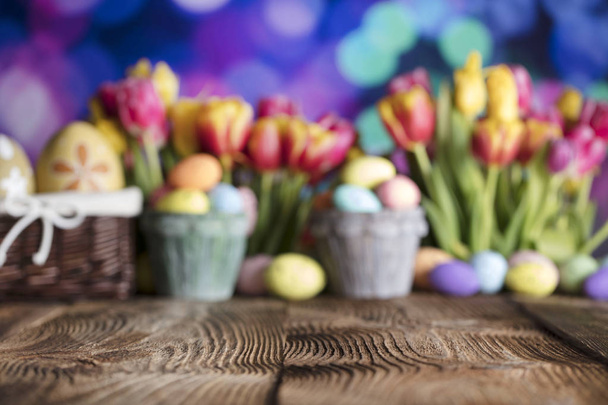 Easter background. Rustic wooden table. Easter basket with eggs. Blue bokeh background. - Фото, изображение