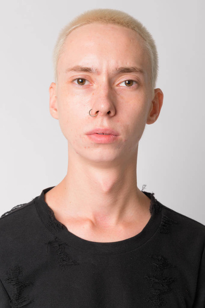 Face of young handsome androgynous man with nose ring - Zdjęcie, obraz