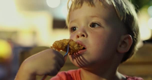 Dreamy boy eating chicken nuggets - Footage, Video