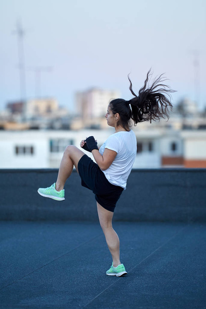 Girl fighter training outdoor in urban environment - Foto, Imagem