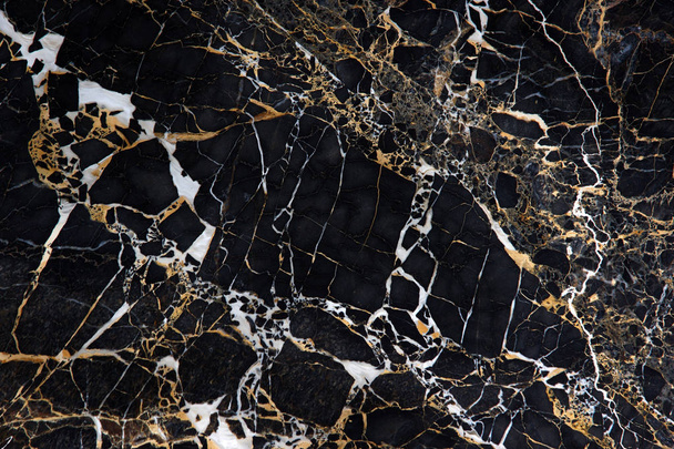 A slab of black marble with beautiful yellow and white veins called New Portoro - Foto, Bild