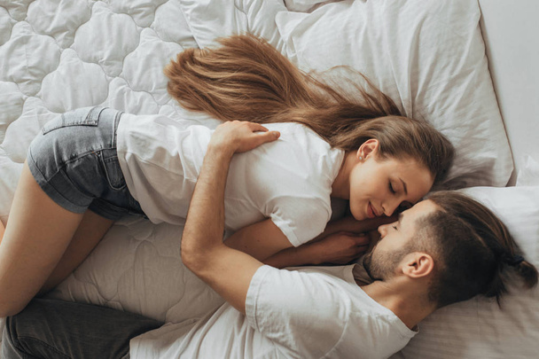 Beautiful loving couple kissing in bed - Foto, Imagem