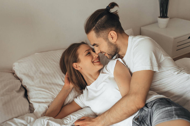 Beautiful loving couple kissing in bed - Foto, immagini