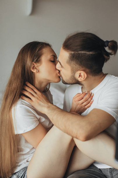 Beautiful loving couple kissing in bed - Zdjęcie, obraz