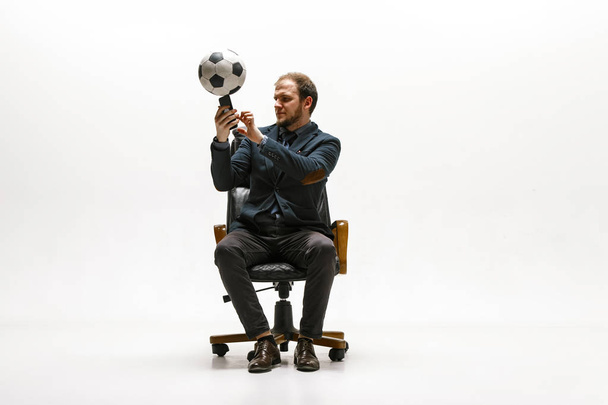 Businessman with football ball in office - Foto, Imagen