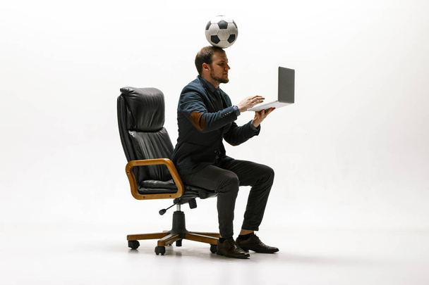 Businessman with football ball in office - Фото, изображение
