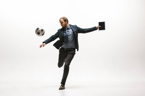 Businessman with football ball in office - Foto, Imagen
