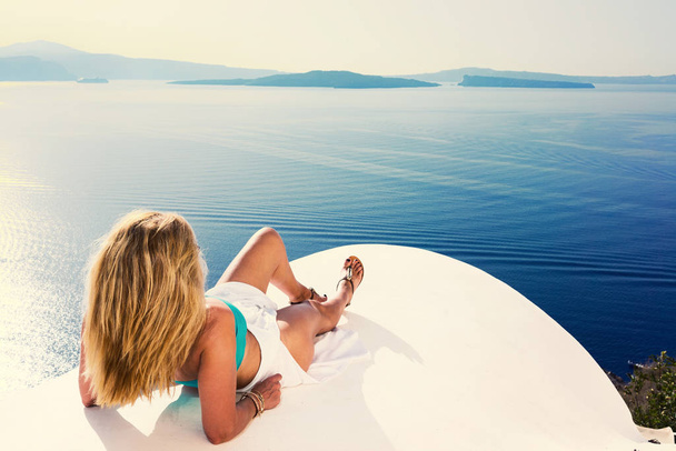 Luxury travel vacation woman looking at view on Santorini island - Valokuva, kuva