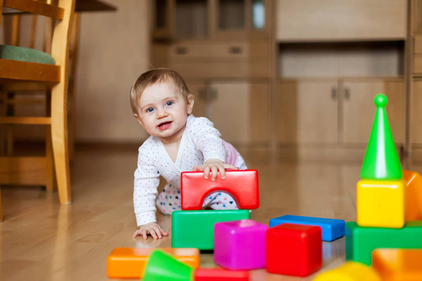 Baby with multi-colored designer at home  - Fotoğraf, Görsel