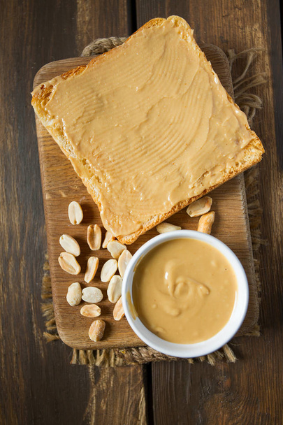 Peanut butter sandwich on wooden surface - Zdjęcie, obraz