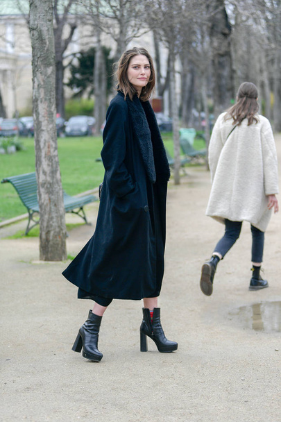 A trendy woman in fashionable outfit is pictured on the street during the Paris Fashion Week Fall/Winter 2019/2020 in Paris, France, 5 March 2019. - Фото, изображение