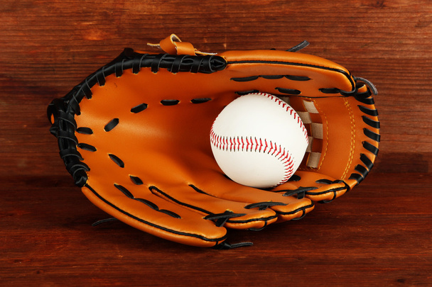 Baseball glove and ball on wooden background - 写真・画像