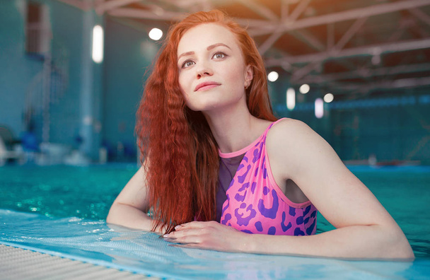 Beautiful young woman in the indoor swimming pool. Athletic sexy girl. Healthy lifestyle - Fotoğraf, Görsel