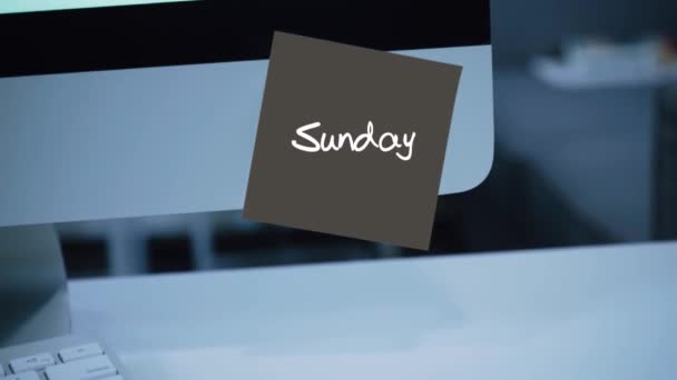 Sunday. Days of the week. The inscription on the sticker on the monitor. Message. Motivation. Reminder. Handwritten text written with a marker. Color sticker. A message for an employee, a colleague - Footage, Video