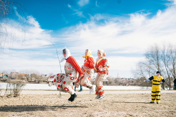 Slavic holiday of the end of winter. Happy girls jumping on a jump rope - Photo, Image