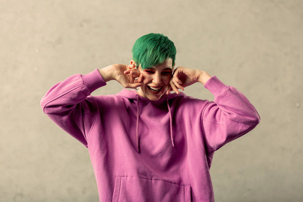Joyful green haired woman showing vivid emotions - Photo, Image