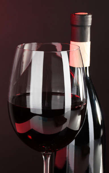 Wine in glass and wine bottle close-up on dark background - Photo, Image