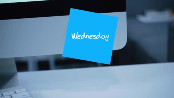 Wednesday. Days of the week. The inscription on the sticker on the monitor. Message. Motivation. Reminder. Handwritten text written with a marker. Color sticker. A message for an employee, a colleague - Footage, Video