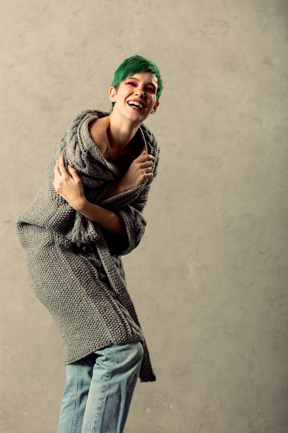 Delighted happy woman wearing a grey cardigan - Foto, Imagen