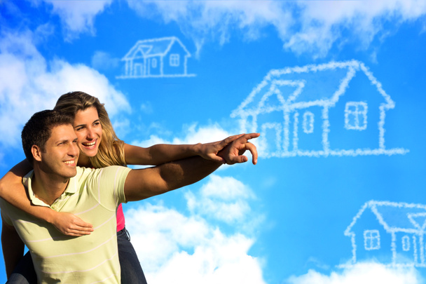 Happy coupleunder the blue sky dreaming of a house. - Photo, Image