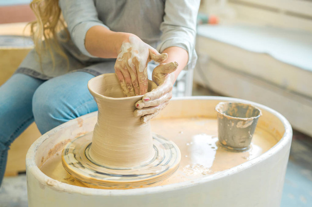 girl makes a jug of his own hands in a pottery workshop - Фото, изображение