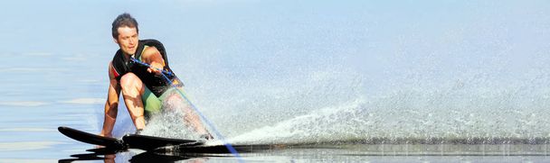 closeup man riding water skis on lake in summer at sunny day. Water active sport. Space for text. Panoramic view - Photo, Image