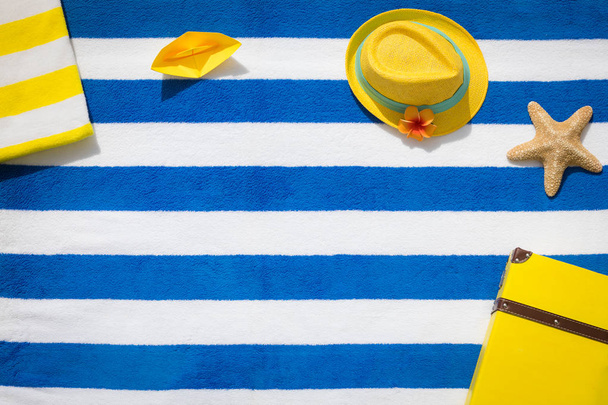Suitcase and hat on striped beach towel - Zdjęcie, obraz