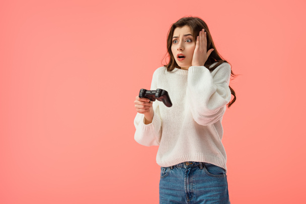 shocked girl holding joystick while standing isolated on pink  - Фото, зображення