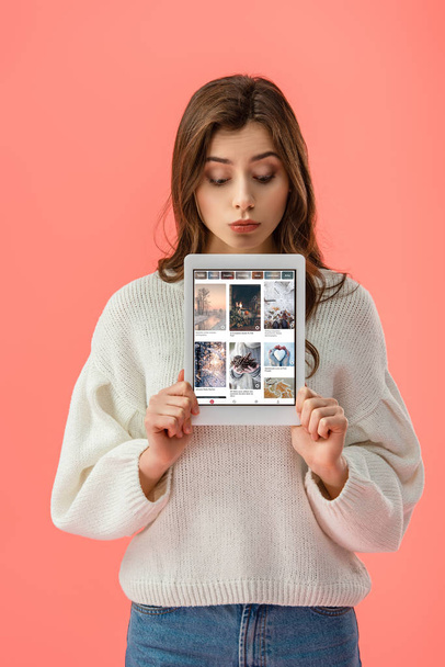 attractive young woman holding digital tablet with tumblr app on screen isolated on pink  - Photo, image