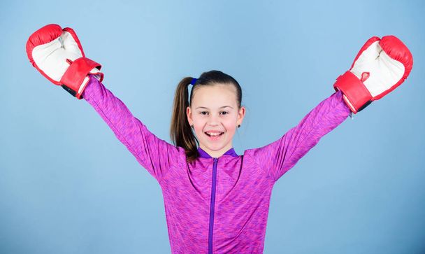Doing her best. Sport success. sportswear fashion. Happy child sportsman in boxing gloves. Fitness diet. energy health. workout of small girl boxer. punching knockout. Childhood activity - Photo, image