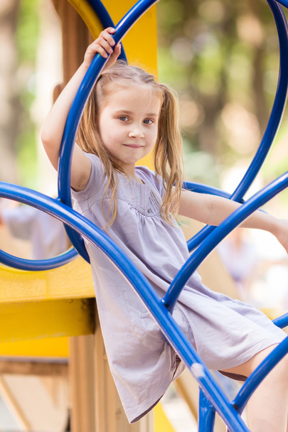 Beautiful little girl on outdoor playground - Фото, зображення