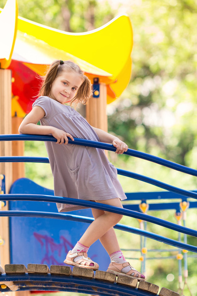 Beautiful little girl on outdoor playground - Foto, afbeelding