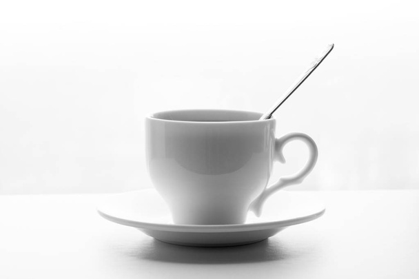 white cup of tea or coffee with spoon and saucer on white background - Photo, Image