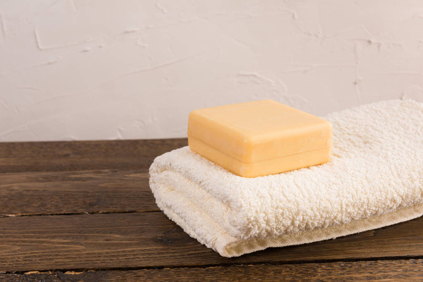 soap and towel on a wooden shelf in the bathroom. Interior of bathroom. - Фото, зображення