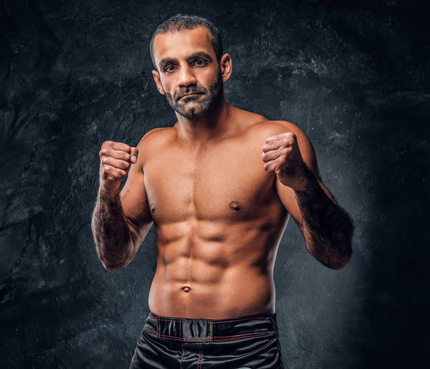 Portrait of a brutal professional fighter with naked torso posing for a camera. - Foto, Bild