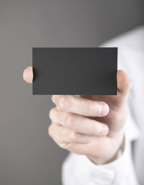 A man holding black business card - Zdjęcie, obraz